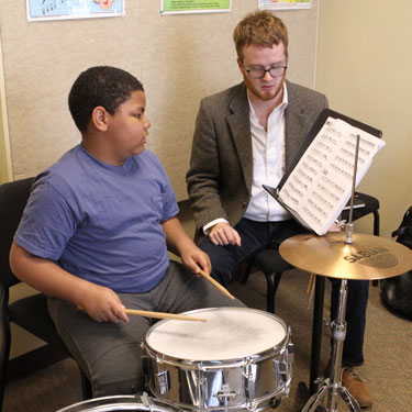 Student and teacher in percussion lesson.
