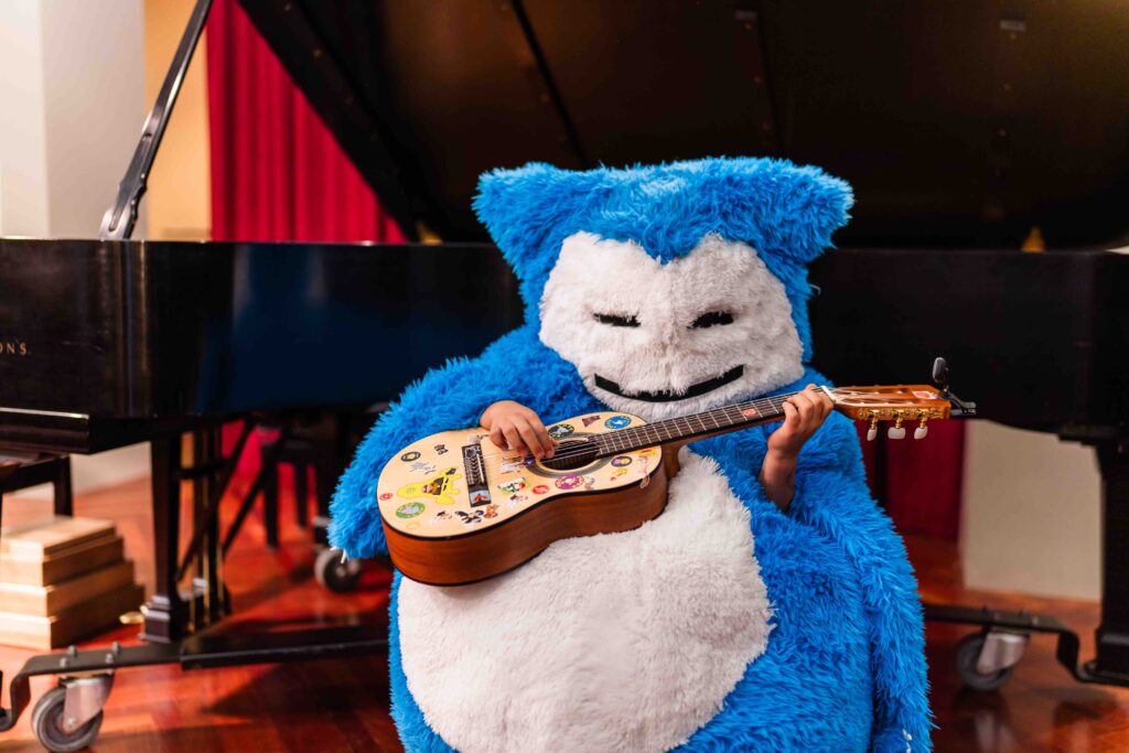 A costumed Suzuki guitar student performing at Boo Bash.