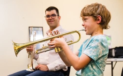 Levine faculty member Philippe Brunet teaches a Suzuki trumpet lesson.